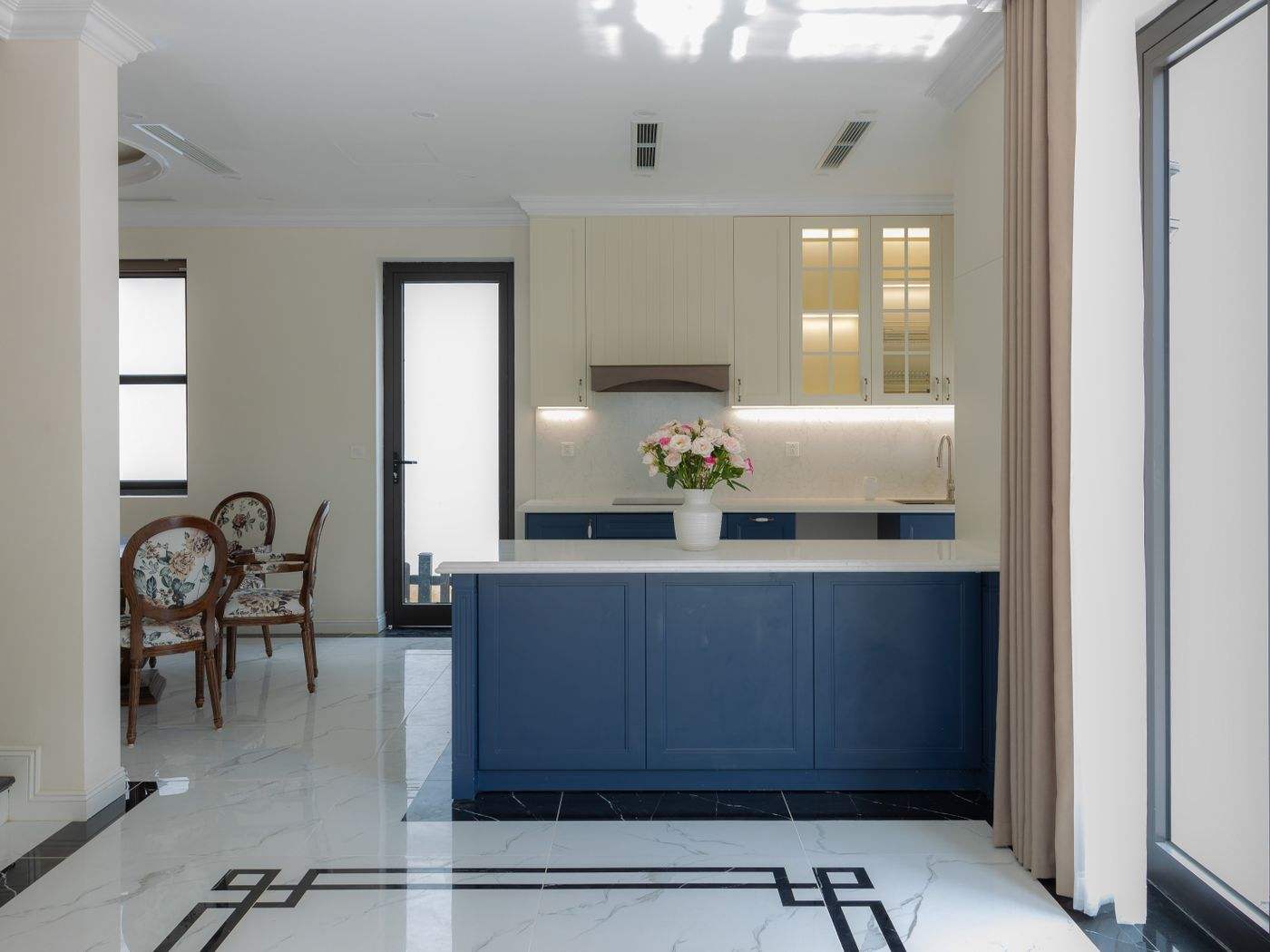 Blue painted kitchen cabinets and island, a popular color for cabinet painting in Boston
