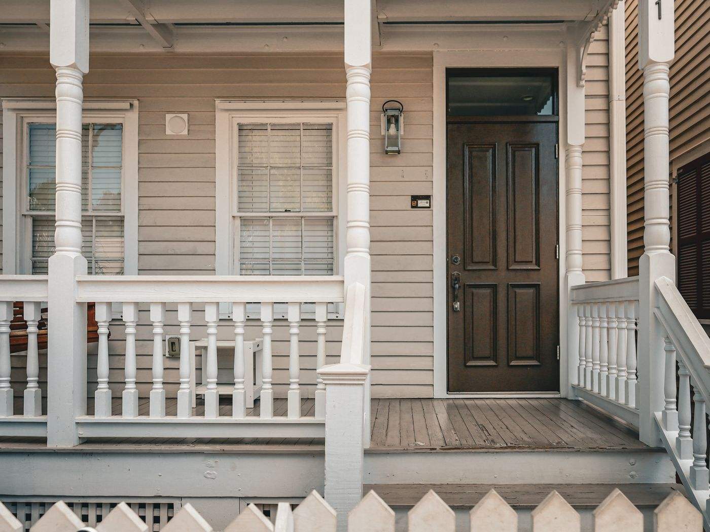 Painted front porch with white railings and steps, part of porch and deck painting