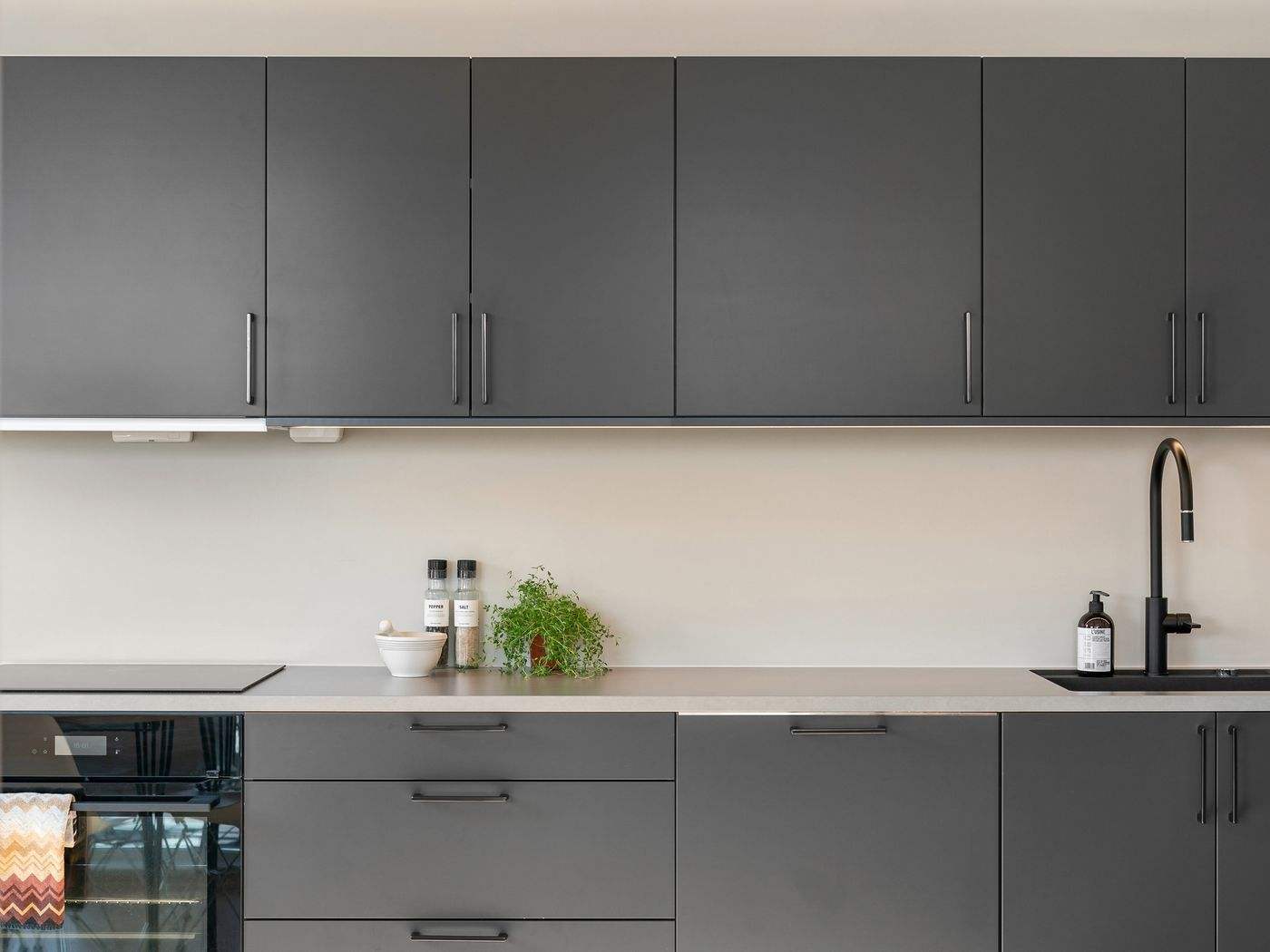 Dark kitchen cabinets in a modern condo, an option for cabinet painting in Cambridge