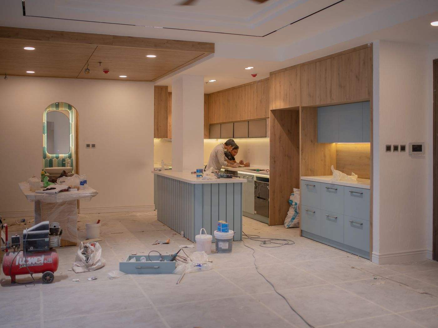 Kitchen being refinished with floors covered, as in a cabinet refinishing project in Boston