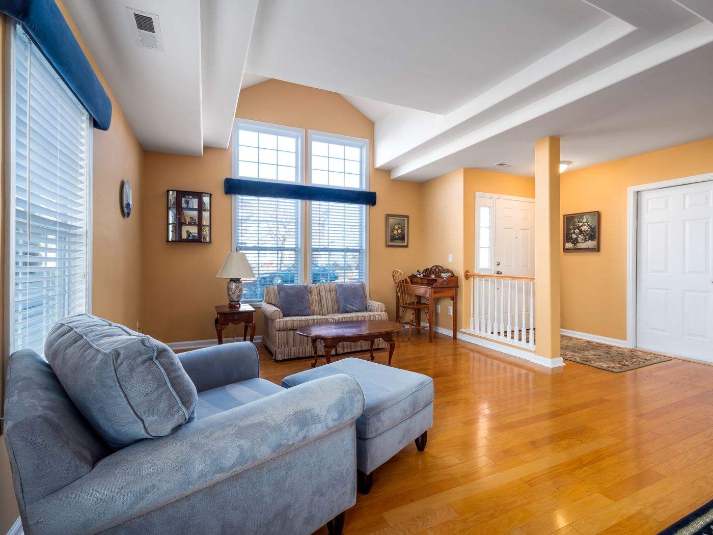 Freshly painted living room with a blue armchair, an example of interior painting in a Boston home